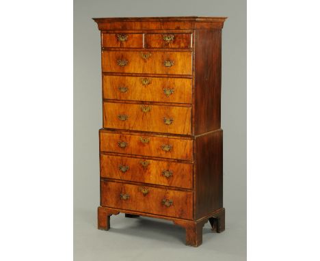 An 18th century walnut tall boy, in two sections, the top half with a moulded cornice above two short and three long graduate
