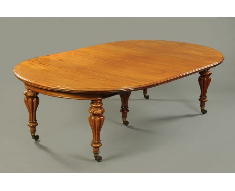 A Victorian mahogany extending dining table, with two leaves, recessed frieze and raised on five turned tapered legs terminat