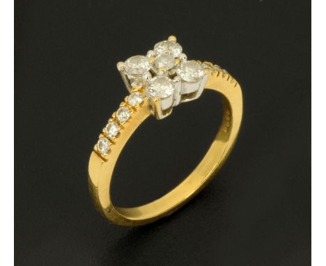 An 18 ct gold ladies five stone diamond ring, with diamond set shoulder, stamped "18 k", size M.