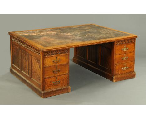A large late 19th century Arts & Crafts partners desk, the rectangular top with tooled leather writing surface, each pedestal