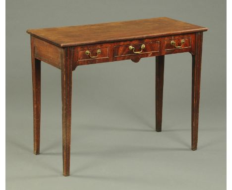 A 19th century mahogany side table, with moulded edge above three frieze drawers with brass drop handles and raised on tapere