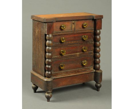A Victorian mahogany miniature Scotch chest of drawers, raised on short turned feet.  Width 39 cm. 
