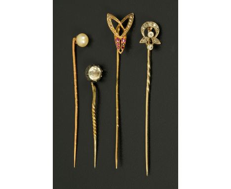 An 18 ct gold and pearl set stick pin, a similar diamond pin, ruby pin and another. 