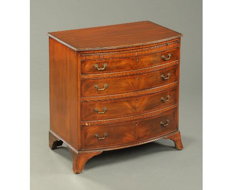 A mahogany chest of drawers, bowfronted, with slide, four long graduated drawers with brass drop handles and raised on splaye