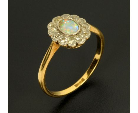 An 18 ct gold platinum set opal ring, size P.  CONDITION REPORT: The ring is stamped 18 ct and judging by the design of the s