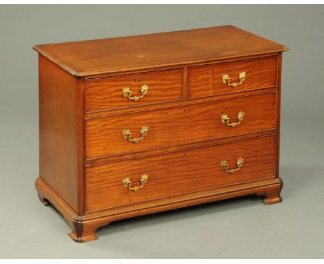 A Victorian mahogany chest of drawers, with moulded edge, rounded corners, two short and two long graduated drawers with bras