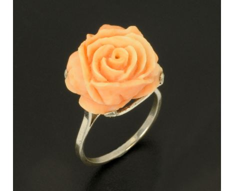 A coral ring, set in white coloured metal, shank size R.