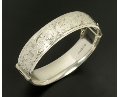 A George Jensen hinged embossed silver bangle.  Width 1.5 cm. 