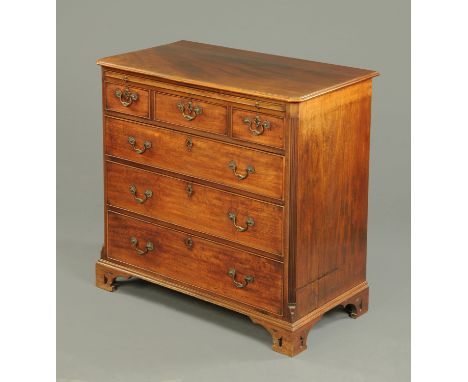 A George III mahogany chest of drawers, with slide above and three short and three long graduated drawers with brass drop han
