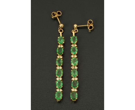 A pair of emerald and diamond ear studs, each with six emeralds and ten diamonds. CONDITION REPORT: Both ear studs are in ext