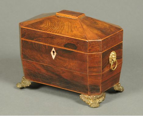 A Regency rosewood tea caddy, boxwood strung and with brass handles and feet.  Width 22 cm (see illustration). 
