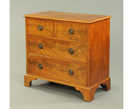 A Victorian mahogany chest of drawers, two short and two long graduated drawers with brass drop handles with octagonal backpl