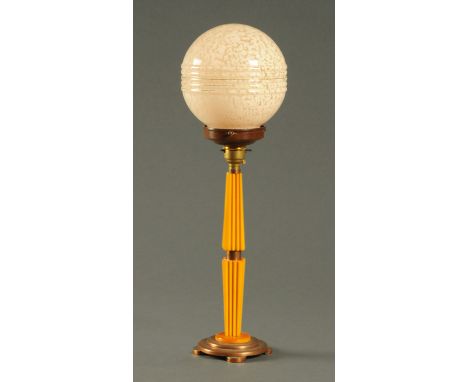An Art Deco amber Bakelite and copper table lamp, with pink glass shade.  Height 47 cm. CONDITION REPORT: The lamp is in gene