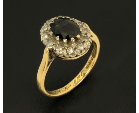 An 18 ct gold sapphire and diamond cluster ring, size K.