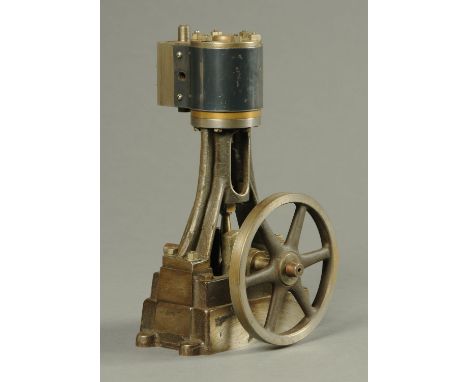 A vertical stationary model steam engine, with 4.75 inch fly wheel.  Height 10 ins, width 5.5 in, length 6 ins. 