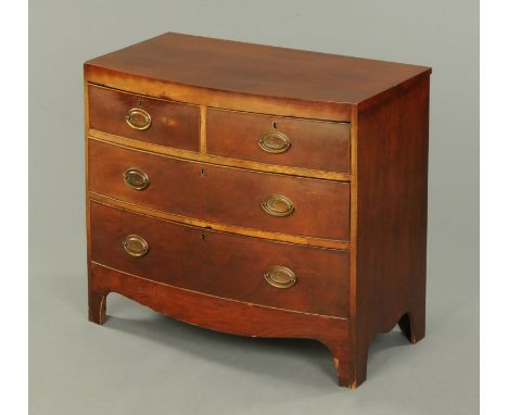 A George III mahogany bowfronted chest of drawers, with two short and two long graduated drawers with brass drop handles the 
