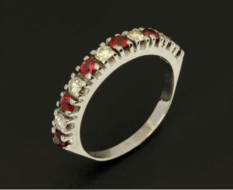 An 18 ct white gold diamond and ruby half hoop ring, size Q/R.