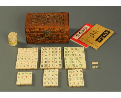 A bone and bamboo Mahjong set, in camphorwood box, with book of instructions. CONDITION REPORT: We are not experts in Mahjong