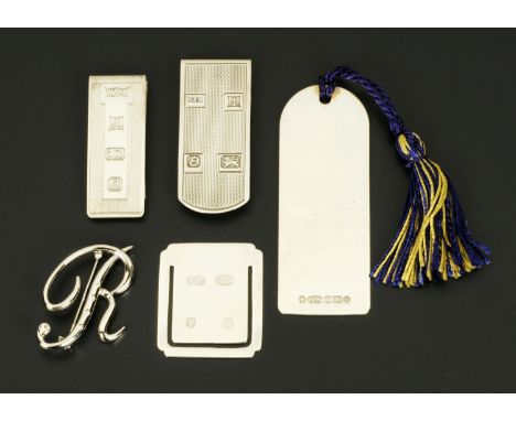 Three silver money clips, a silver bookmark and a letter R brooch.