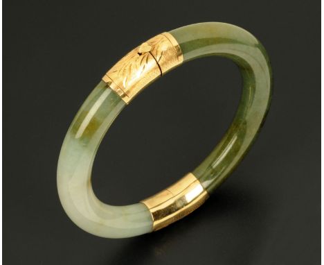 A jade bangle, with gold coloured metal binding and clasp.  External diameter 87 mm (see illustration).
