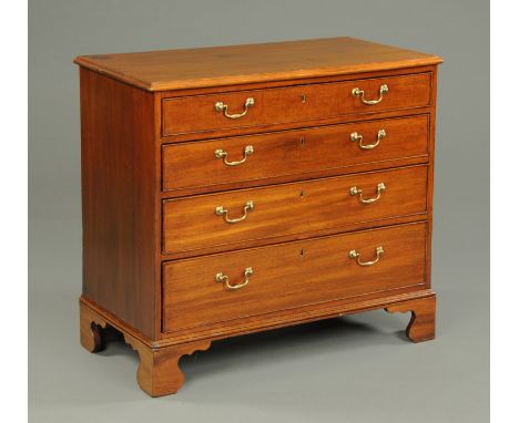 A late Georgian mahogany chest of drawers, with moulded edge above four long graduated drawers with brass drop handles and co