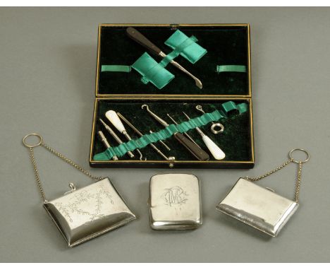 A silver cigarette case, two plated purses and a cased manicure set.  