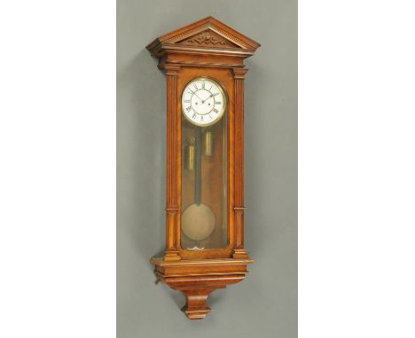 A 19th century walnut Vienna regulator wall clock, with triangular pediment, two-train weight driven movement, bearing stamp 