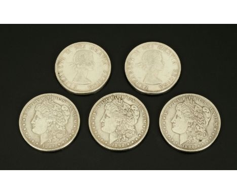 Three Morgan dollars, 1889, 90 and 98, and two Canadian dollars.