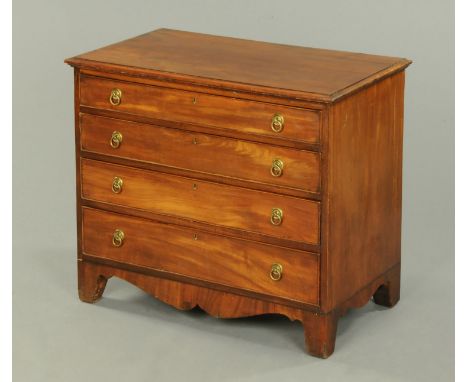 A George III mahogany chest of drawers, with moulded edge above four long graduated drawers with circular drop handles, circu