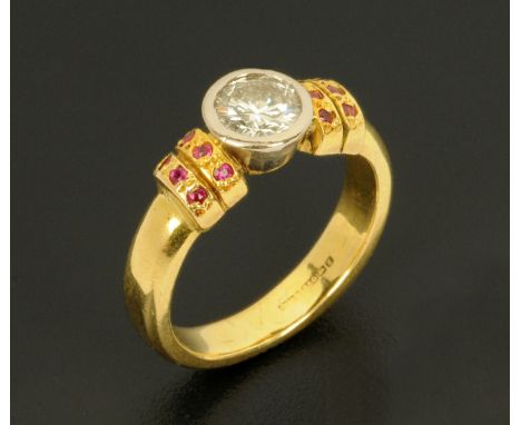 An 18 ct yellow gold diamond solitaire ring, with small rubies to each shoulder, size K/L, diamond diameter +/- 6 mm. 