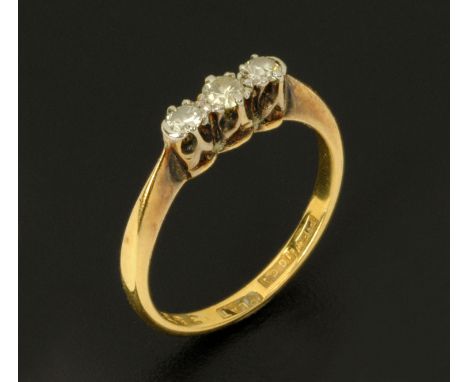 An 18 ct gold and platinum three stone diamond ring, size K/L.