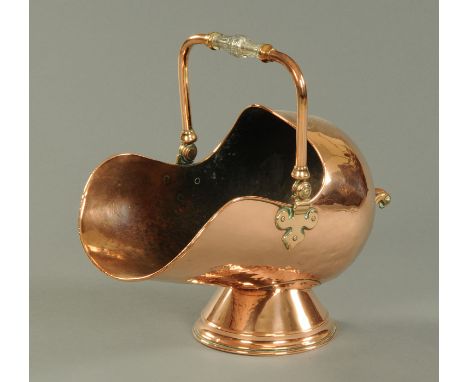 A Victorian copper coal helmet, with glass and brass loop handle.