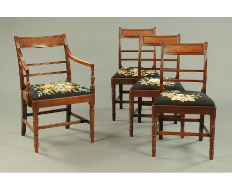 A set of one carver arm and three single Regency mahogany dining chairs, in the Whitehaven style, each with drop in floral ta