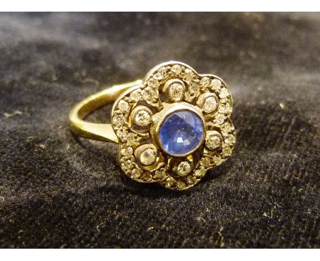 An 18ct Yellow Gold Sapphire and Diamond Cluster Ring, set with a central sapphire surrounded by diamonds within a cluster