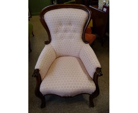 A Victorian Mahogany Drawing Room Armchair, with a partly upholstered button back above a stuff-over seat, with carved scroll