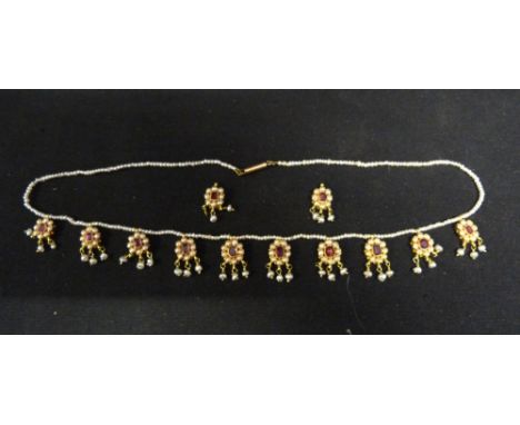 An Early 19th Century Sea Pearl Fringe Necklace set with ten gold drops each with a central ruby surrounded by pearls and wit