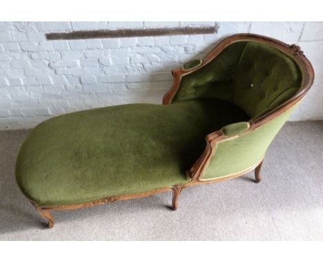 A French Day Bed, with a carved and partly upholstered button back with scroll arms above a carved frieze raised upon cabriol