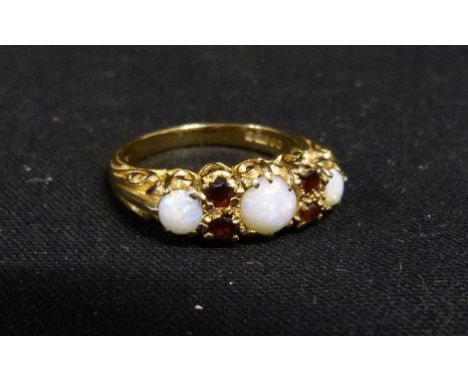 A 9ct. Gold Opal and Garnet Dress Ring, set three opals and four garnets within a pierced setting