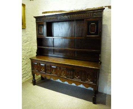 A Late Georgian Oak Dresser, the boarded shelf back above three moulded drawers with brass handles raised upon turned legs wi