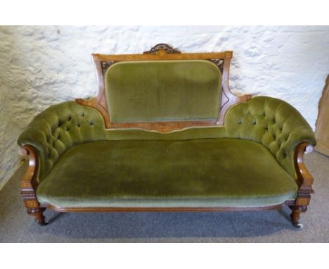 A Late Victorian Walnut and Marquetry Inlaid Sofa, the partly upholstered and pierced back above button scroll ends with inla