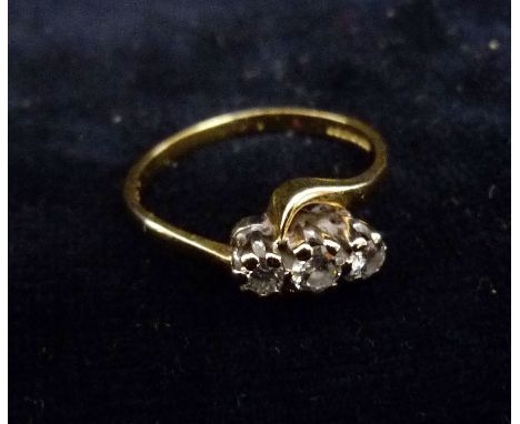 An 18ct. Gold Three Stone Diamond Ring, the three diamonds within a pierced setting 