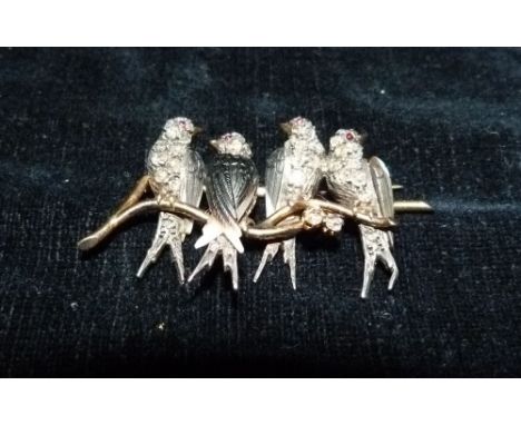 An Early 20th Century Yellow Gold Brooch in the form of four birds upon twigs each set with diamonds and with ruby eyes