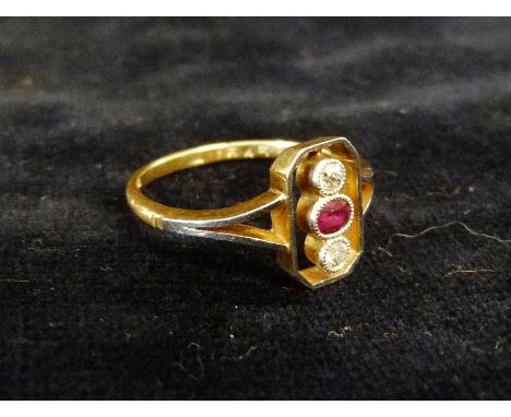 A 9ct. Gold Ruby and Diamond Ring with a central ruby flanked by diamonds within a pierced setting