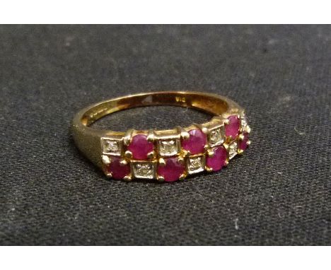 A 9ct. Gold Ruby and Diamond Dress Ring, set with seven rubies and seven diamonds within a pierced setting