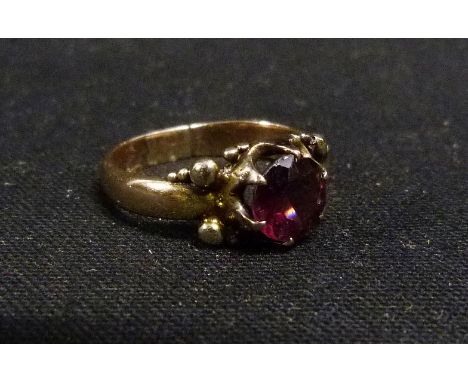 A Yellow Metal Dress Ring set single amethyst within a pierced setting