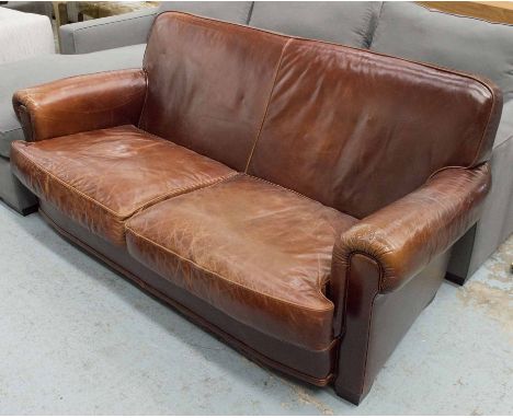 SOFA, in worn brown leather with two seat cushions, 185cm W.