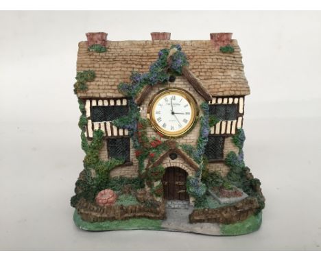 A Wm Widdop quartz mantel clock in the form of a house, 15cmH 