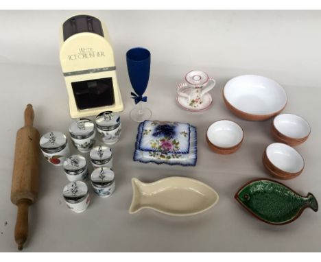 A small selection of kitchen items including an ice crusher, a rolling pin, a butter dish, a serving bowl with six smaller bo