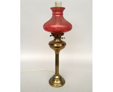 An electric converted gas lamp with pink glass shade and chimney 68cmH