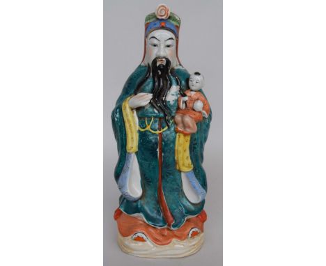 A ceramic Chinese figure of Fuxing, one of the Sanxing, holding a child 39cmH